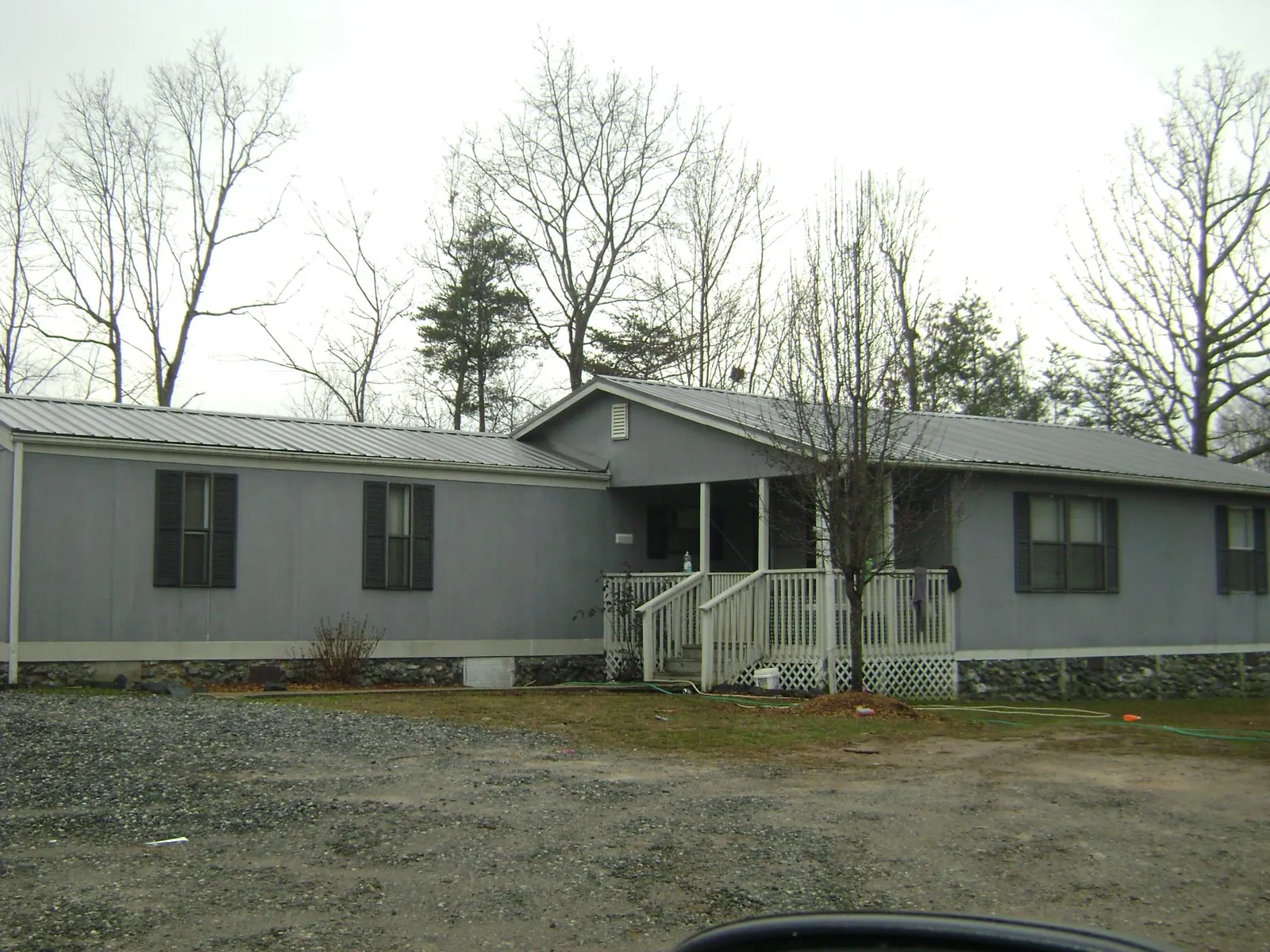Metal roof over a manufactured home with a covered front porch in Rich Square